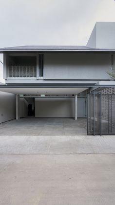 an empty parking garage in front of a house