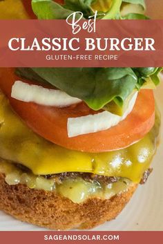 a hamburger with lettuce, tomato and cheese on it is sitting on a plate