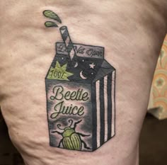 a tattoo on the leg of a person with a juice carton