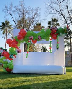 an inflatable arch decorated with balloons and candy canes