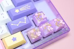 a close up of a purple keyboard with gold decorations on it's keys and numbers