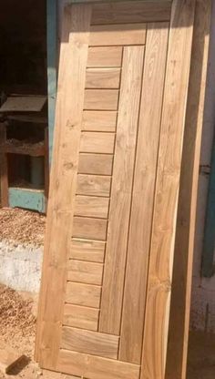 an open wooden door in front of a building