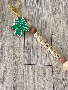 a wooden keychain with a christmas tree on it