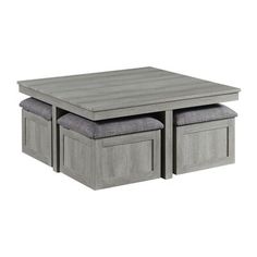 a grey coffee table with two storage drawers and one bench underneath it, on a white background