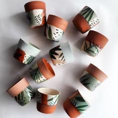 nine cups with different designs on them sitting next to each other in the shape of a circle