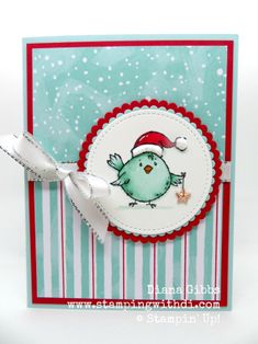 a close up of a card with a small bird on it's side and a ribbon around the edge