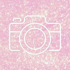 a camera on a pink and white background with small speckles in the foreground