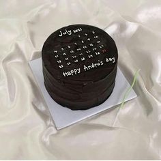 a chocolate cake with white writing on it