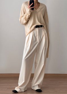 Color: Butter Lightweight wool blend knit Relaxed fit Semi-sheer V-neckline Drop shoulders Vertical contrast stitch detail at back 50% Acrylic 40% Wool 10% Cashmere Dry Clean By The Frankie Shop. Imported Tan Trousers Outfit, Beige Pants Outfit, Tan Trousers, Trouser Outfit, The Frankie Shop, Beige Pants, Frankie Shop, Suit Style, High Waisted Trousers