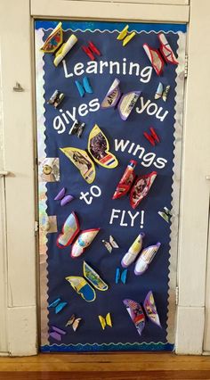 a door decorated with magnets and paper clips that say learning gives you wings to fly