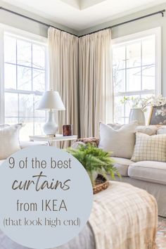 a living room filled with furniture and pillows on top of a rug next to a window