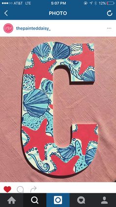 the letter c is made out of fabric and has shells on it, as well as an ocean theme