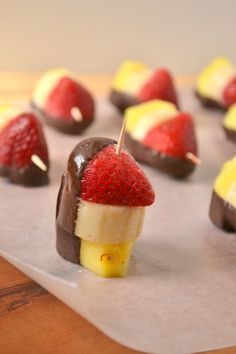 chocolate covered strawberries and other desserts on a table