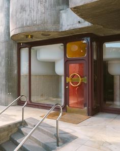 an open door to a building with metal handrails on the outside and inside