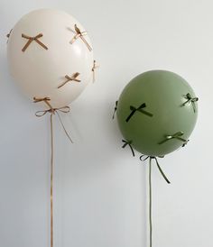 two balloons with crosses attached to them are hanging on the wall next to each other