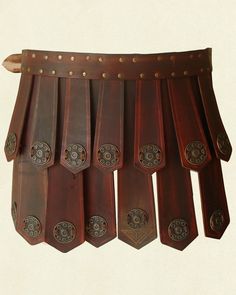 a group of wooden pieces hanging from the side of a wall with rivets on them