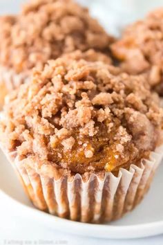 some muffins are sitting on a white plate