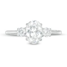 an oval diamond ring with three round diamonds