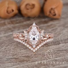 a close up of a ring on a wooden surface with nuts in the back ground