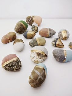 several different types of rocks on a white surface