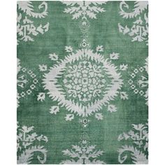 a green rug with white designs on it