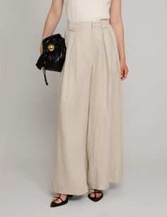 Oat linen wide leg pants . Styled with matching oversized vest . 70% tencel, 30% tencelFully lined Side pockets Back elastic waist Wide leg Size s waist is 26-27", hips 38"Size m waist is 28-29", hips 40"Model wears size S and is 5.8"/ 1.70 cmImported Flax Wide-leg Pants With Pockets, Chic Cotton Bottoms In Flax Color, Spring Full-length Linen Bottoms, Wide Leg Pants With Pockets For Day Out, High-waist Linen Bottoms In Neutral Color, Neutral High Waist Wide Leg Linen Pants, Baggy Wide Leg Pants With Pockets For Day Out, Spring Beige Flax Bottoms, Versatile Linen Wide-leg Pants