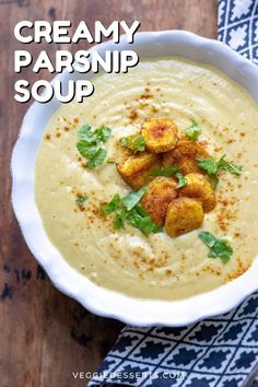 creamy parsnip soup in a white bowl with garnish on top