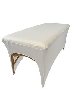 an upholstered white bench with wooden legs