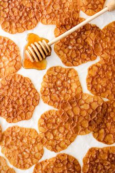 a honeycomb cookie with a wooden spoon in it and some honey on the top