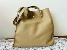 Genuine leather beige tote bag - Genuine leather shopper bag Dimensions :  Height : 34 cm Width : 31.5 cm Depth : 12.5 cm In very good condition For other GENUINE LEATHER BAG please check here : https://www.etsy.com/shop/TheVINTAGEShopBG?ref=l2-shopheader-name&section_id=22456024 All pictures are real . You buy exactly what you see in the photos . Thank you for visiting my store. Please check out my other items 😊 Luxury Neutral Tote Shoulder Bag, Classic Cream Bags With Rolled Handles, Cream Leather Bags With Rolled Handles, Beige Satchel With Rolled Handles For Shopping, Leather Shoulder Bag With Handles In Neutral Color, Neutral Leather Shoulder Bag With Handles, Large Beige Bags For Errands, Travel Shoulder Bag In Beige With Rolled Handles, Neutral Bags With Rolled Double Handles