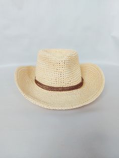 Stylis Cowboy Raffia Fedora Hat  Handmade with care, this hat is made from 100% natural fibers The hat features a beautiful braided lace decoration, adding a touch of elegance to any outfit.  It is also lightweight and breathable, ensuring comfort even on hot summer days.  The wide brim provides excellent sun protection, shielding your face and neck from harmful UV rays. The reguilin tied into the brim helps the hat maintain its shape, ensuring it looks stylish and put-together at all times.  Th Adjustable Braided Straw Hat In Country Style, Adjustable Braided Country Straw Hat, Brimmed Straw Hat For Rodeo, Rodeo Hats With Braided Short Brim, Brimmed Straw Ranch Hats, Rodeo Braided Hat With Short Brim, Western Cream Straw Hat With Short Brim, Cream Western Straw Hat With Short Brim, Western Style Woven Straw Hats