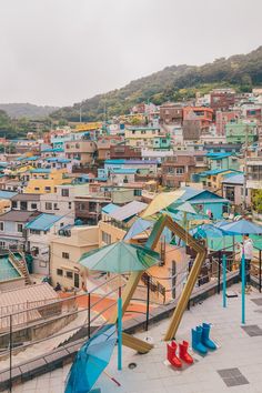 an aerial view of a city with lots of buildings and playground equipment in the foreground