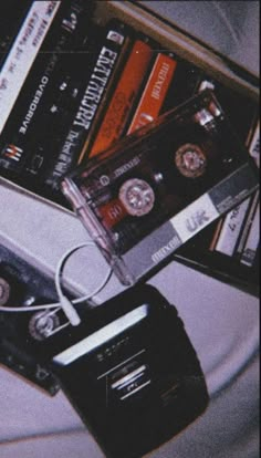 there are several cassettes on top of each other and one is plugged into an mp3 player