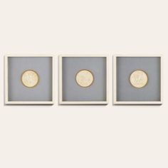 three framed gold coins sitting on top of each other