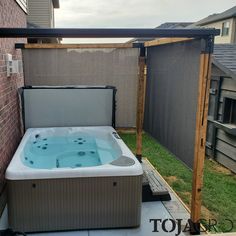 an outdoor hot tub in the back yard