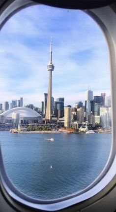 an airplane window looking out at the city