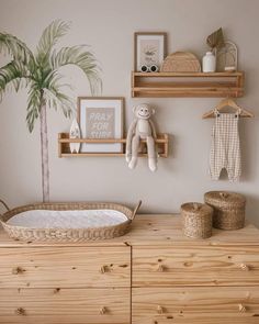 a baby's room with wooden furniture and decor on the wall, including a crib