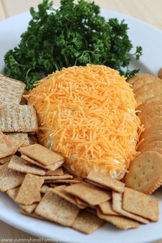 cheese and crackers on a plate with parsley in the middle for garnish