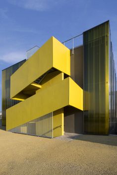 a yellow building that is next to a fence