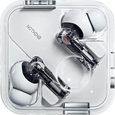 two earbuds sitting in a clear case