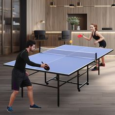 two people playing ping pong in an office setting