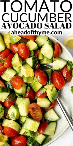 a white plate topped with cucumber and tomato salad