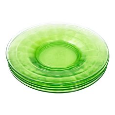 green glass plates stacked on top of each other in the shape of a circle, set against a white background