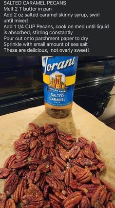 pecans on a cutting board next to a jar of caramel