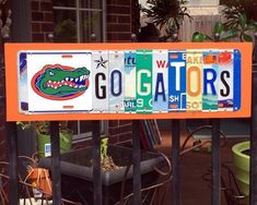 a florida license plate sign with the word go gators on it