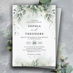 an elegant wedding card with greenery on it