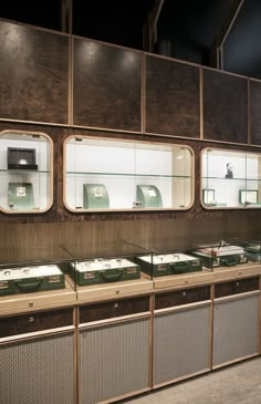 a room filled with lots of different types of items in glass cases next to each other