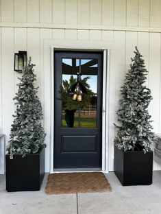 the front door is decorated with christmas trees