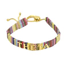 a bracelet with the word faith written on it, in gold and multicolored beads