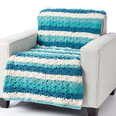 a blue and white blanket sitting on top of a chair